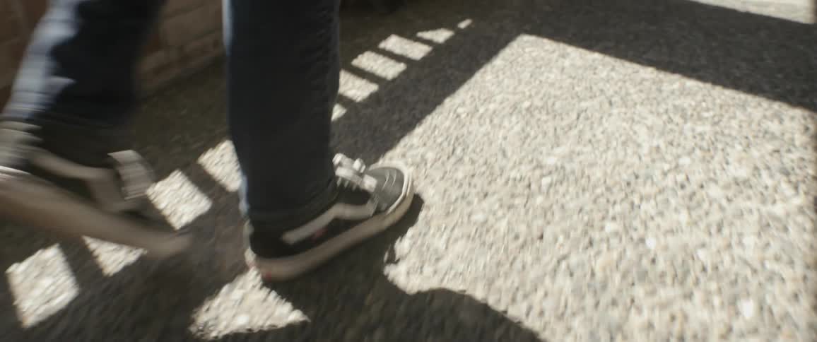The person walks on the bridge on a sunny day