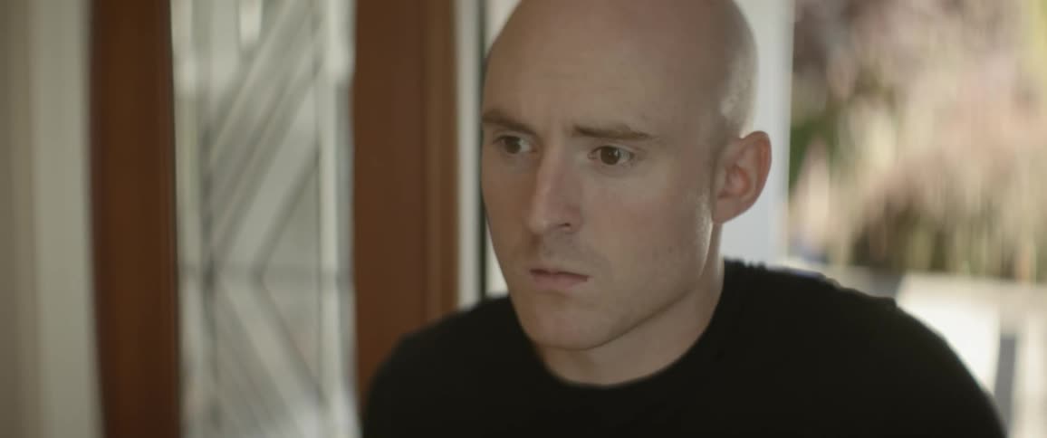 The man enters the room and looks down