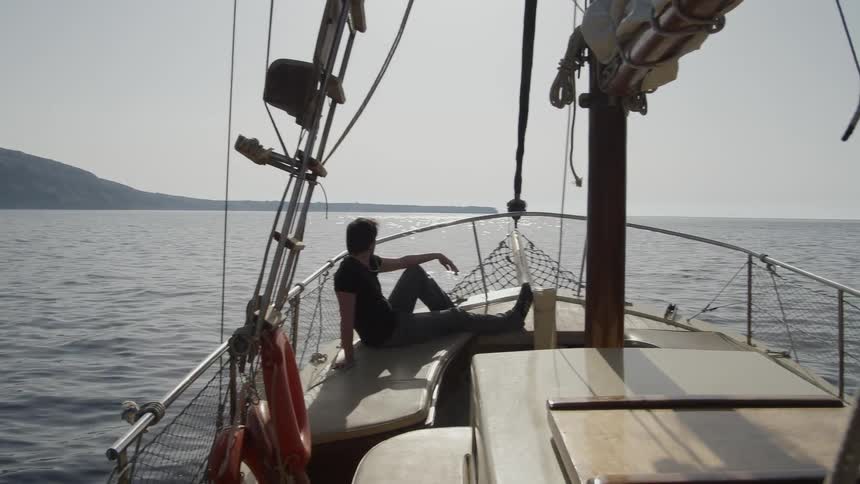 A man is sailing in the ocean