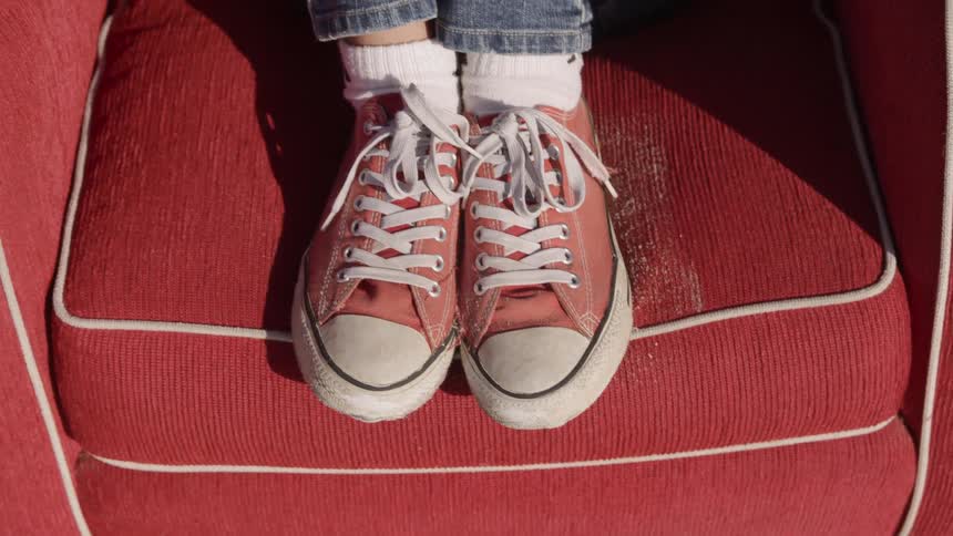 Red converse sneakers on red fabric chair