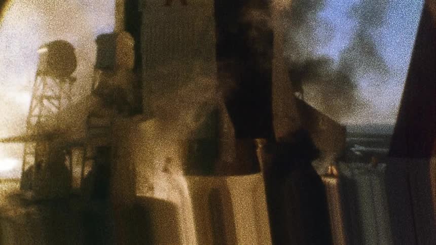 Distorted footage of fire coming out of the engines of a rocket on the launchpad