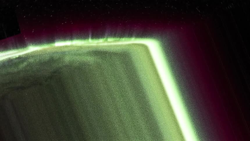 Distorted footage of the green shifting northern lights on the sky