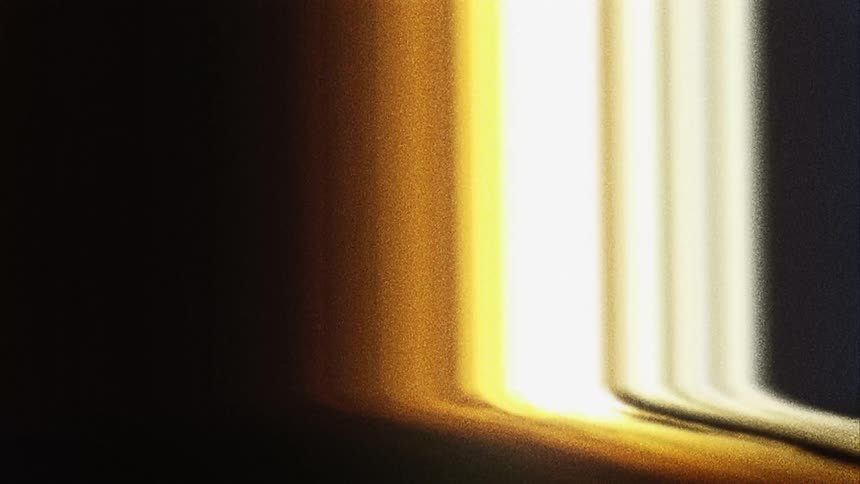 Lines of red yellow and orange light move through the static and the darkness