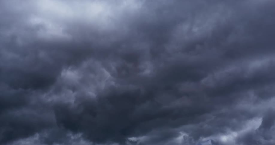 Dark storm clouds cover the blue as they move across the sky