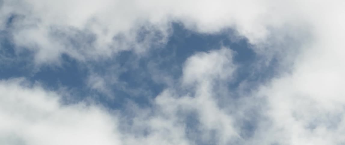 Fluffy white clouds floating in the blue sky