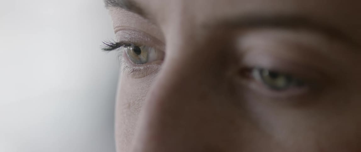 Light reflects on a persons pupils as they look and then they blink