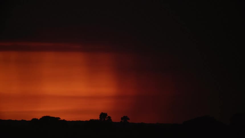 A storm coming in during a red sunset