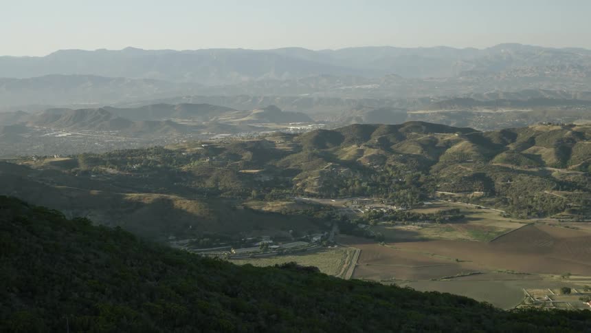 A village sits at the bottom of the hill