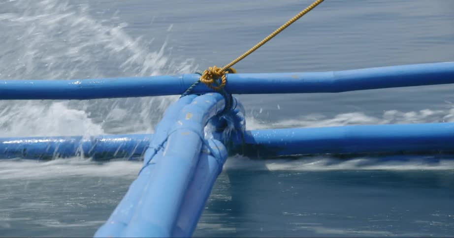 A wakeboard boat pulls a long rope