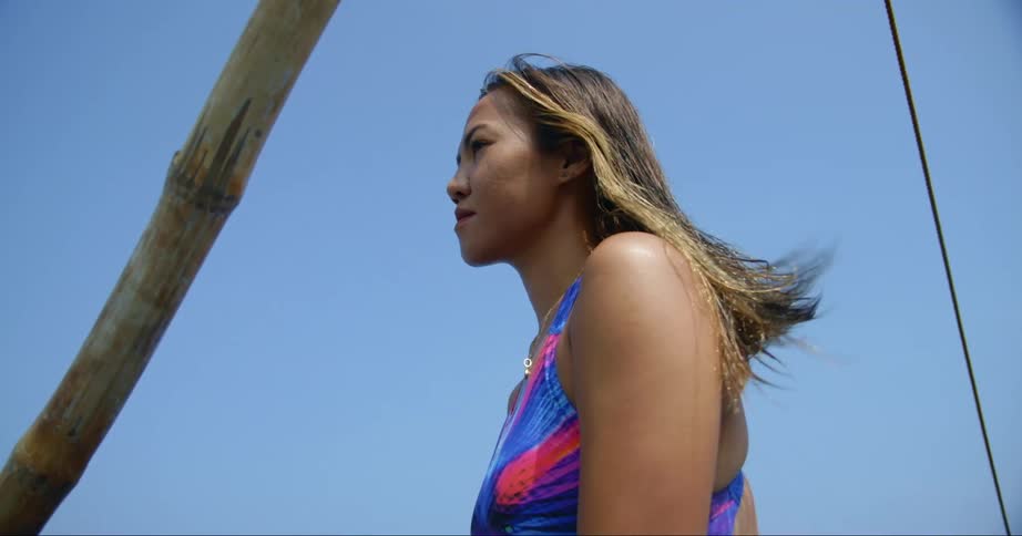 Portrait of a woman wearing a bikini on a boat in the daytime