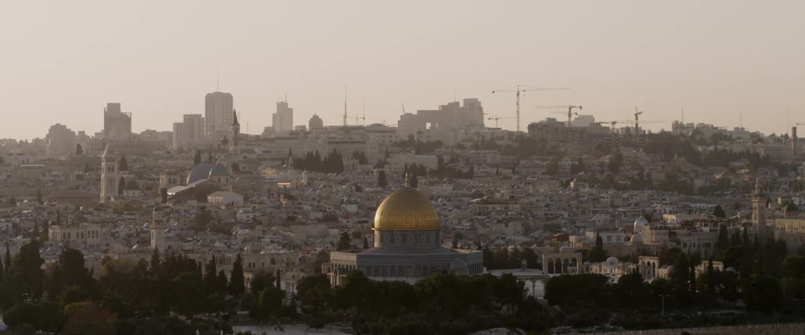 A gold domed building in a city