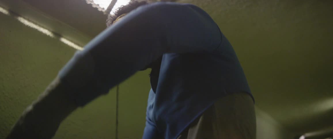 A man is twisting around breakdancing