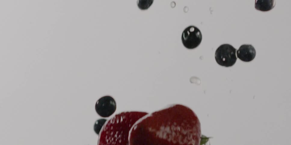 Water and berries fall through the air