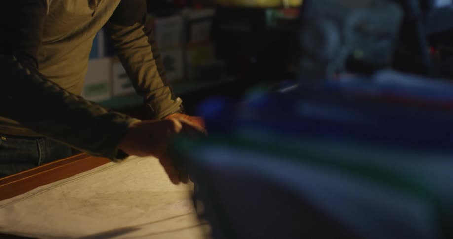 Man studies a map on his desk