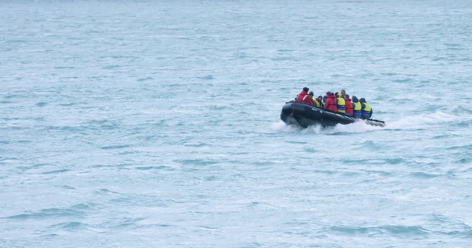 Many people sit on a small motorized watercraft