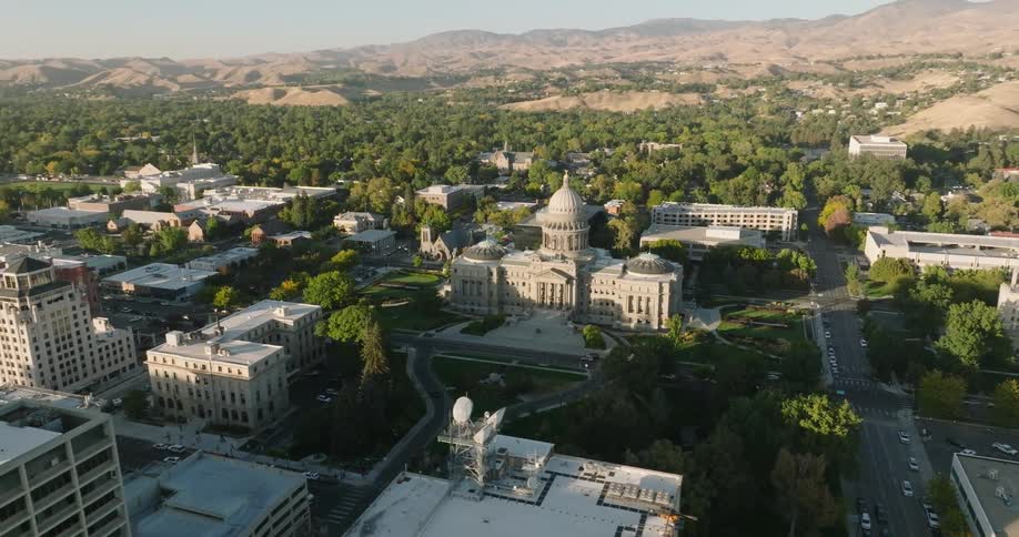 Orbiting aerial view of the city hall in a small town at morning