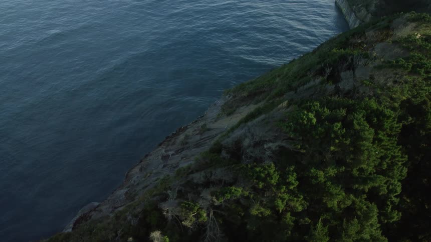 An aerial view of a waterway next to a cliff