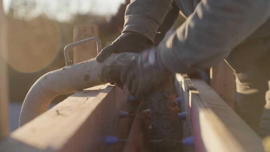Workers are pouring concrete on the construction site
