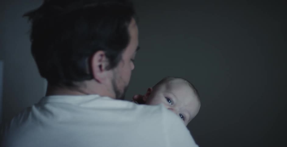 Father is holding baby around the day time