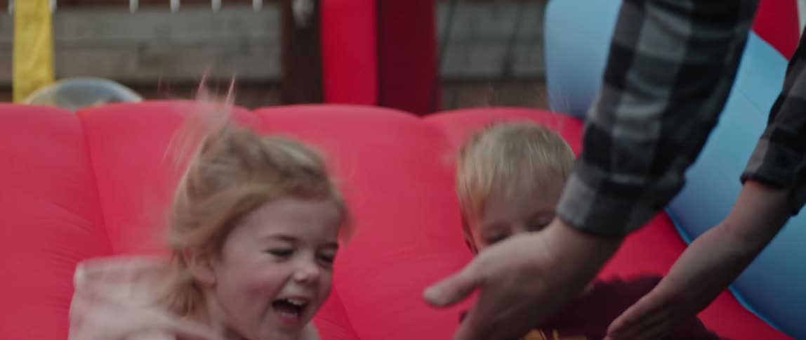 Toddlers are outdoors and they are laughing together