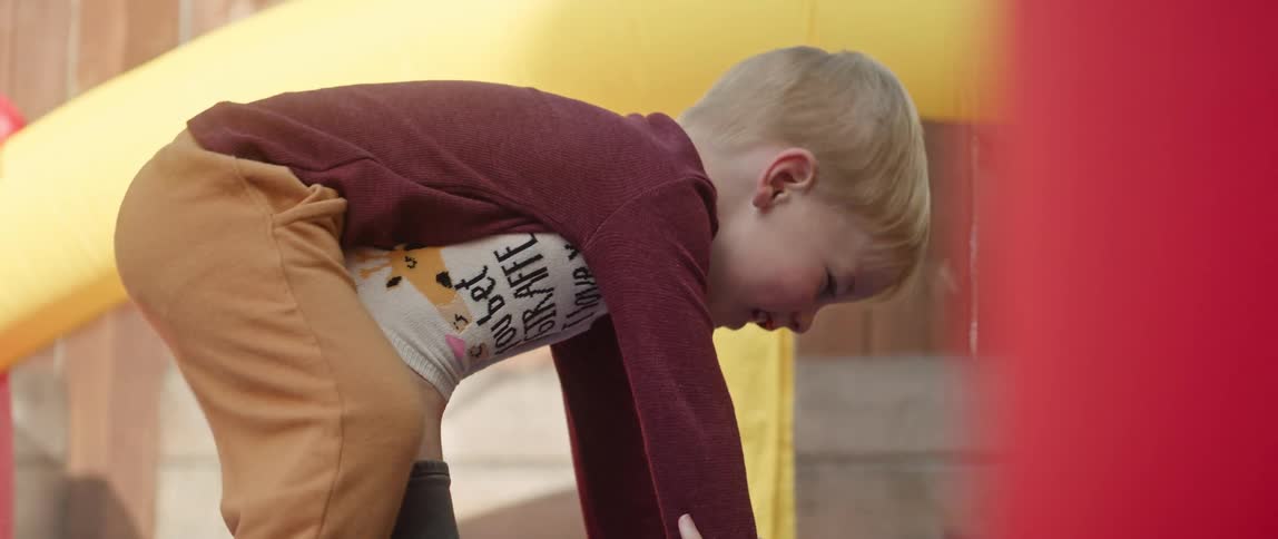 Father and son are playing around inside of a tent