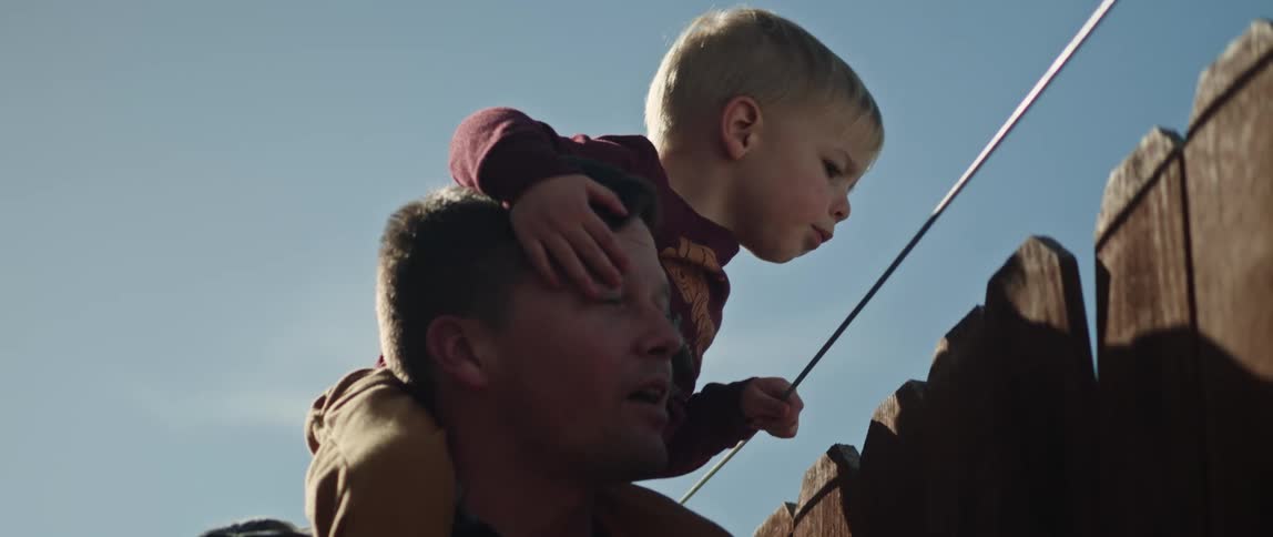 Father and son are outdoors hanging out around the day