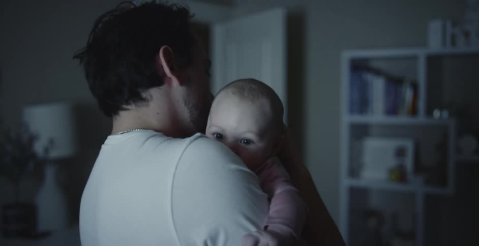 Father is holding baby in the middle of the day time