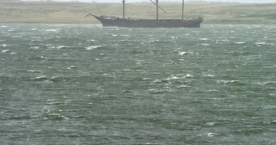 A three masted boat sits in the water
