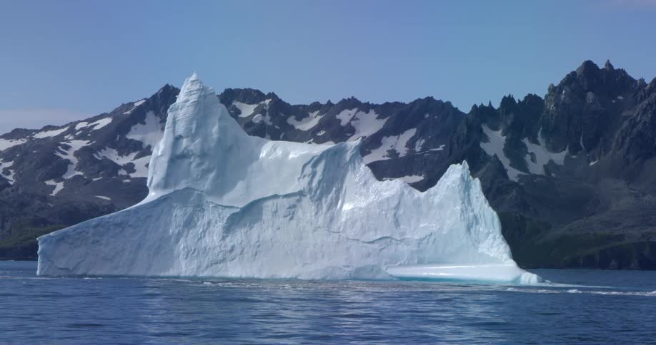 An iceberg is floating near the shore