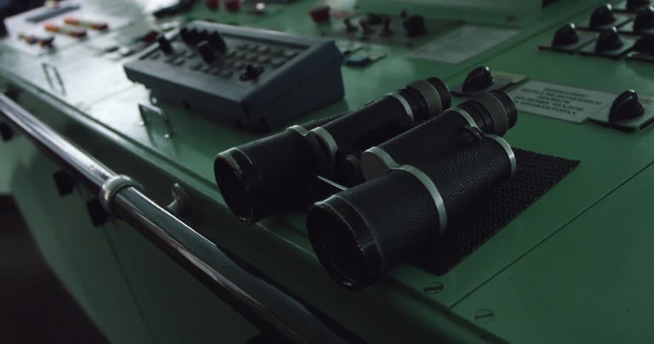 A pair of binoculars are on this control deck