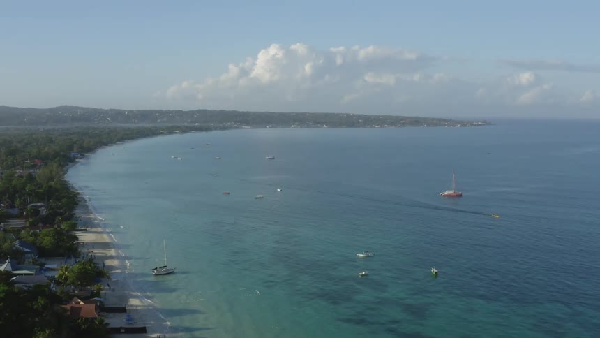 Aerial view of a coastal caribbean town next to the ocean at daytime