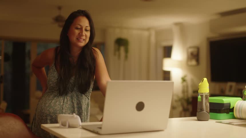 A woman is talking on the laptop