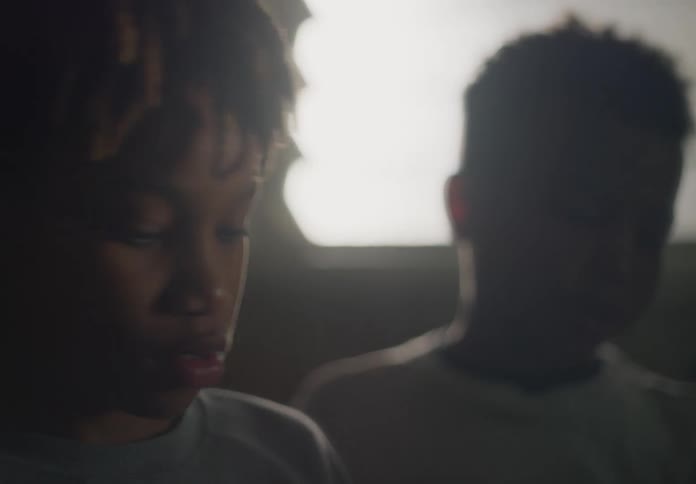 Close up of boys with dreadlocks looking down
