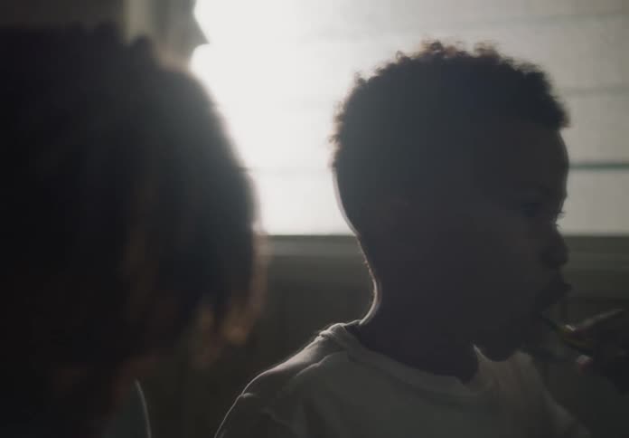 Two tween brothers standing in bathroom brushing teeth reflection of the mirror