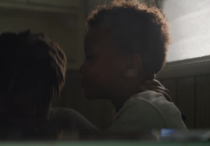 Two brothers play fighting strangling each other laughing and smiling indoors