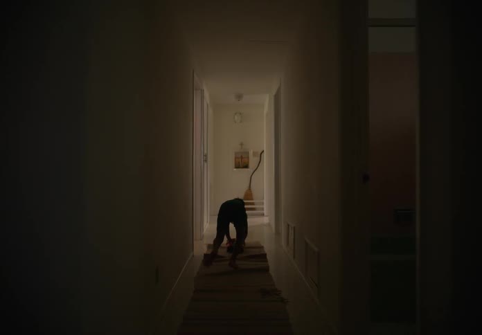 Boy plays with toy in the corridor of house