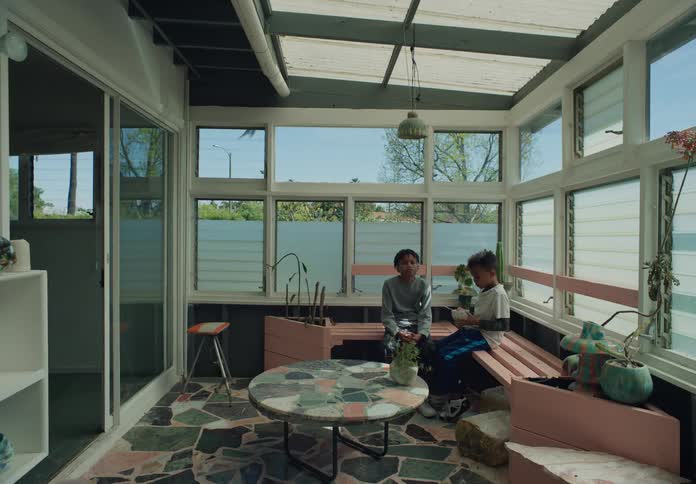 Brother sharing breakfast on the balcony at daytime