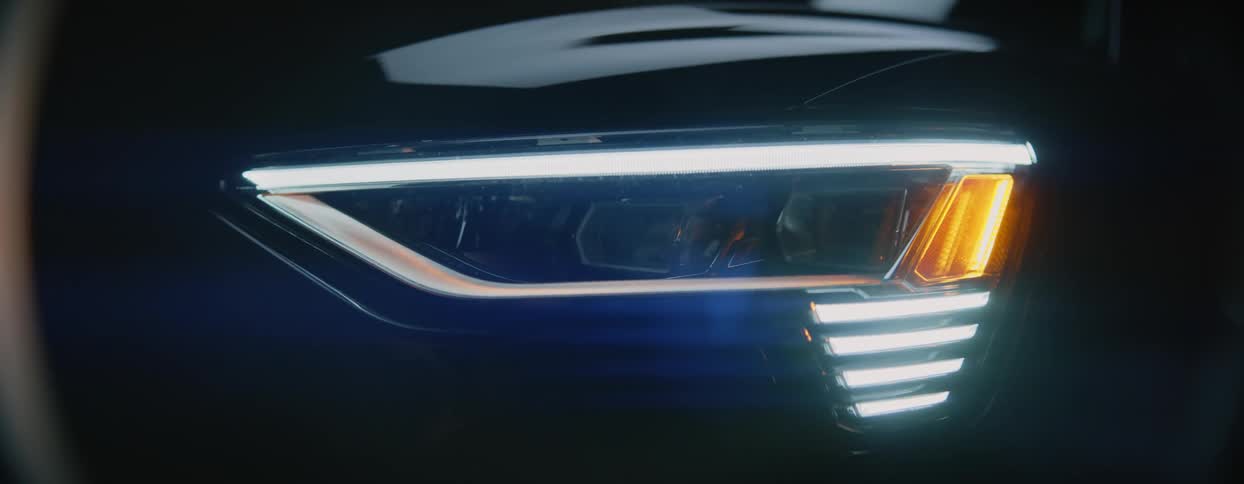 A close up of a car headlight at night