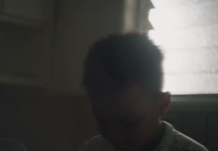 Two boys wipe their faces with a towel