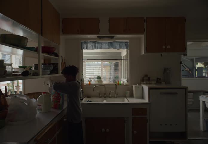 A child is pouring a bowl of cereal