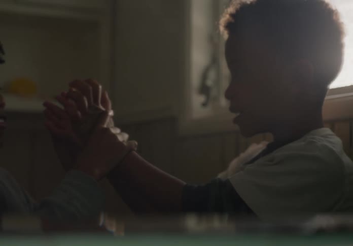 Two tween brothers play fighting smiling and having fun at home indoors