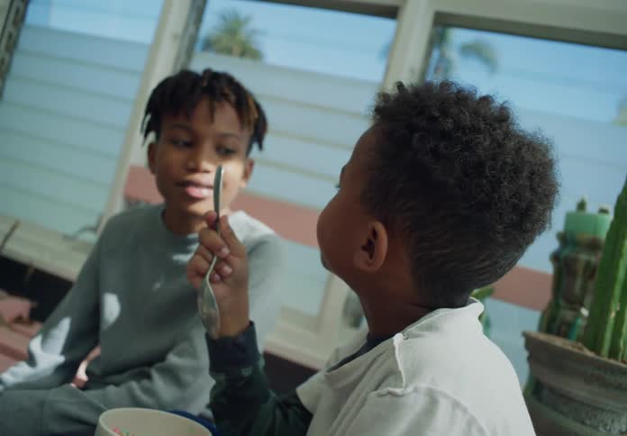 A child is eating cereal at home