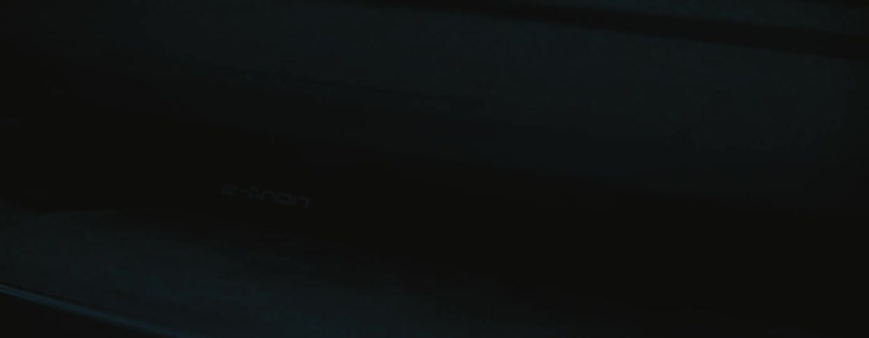 Abstract closeup of audi etron grill with light and shadow moving across