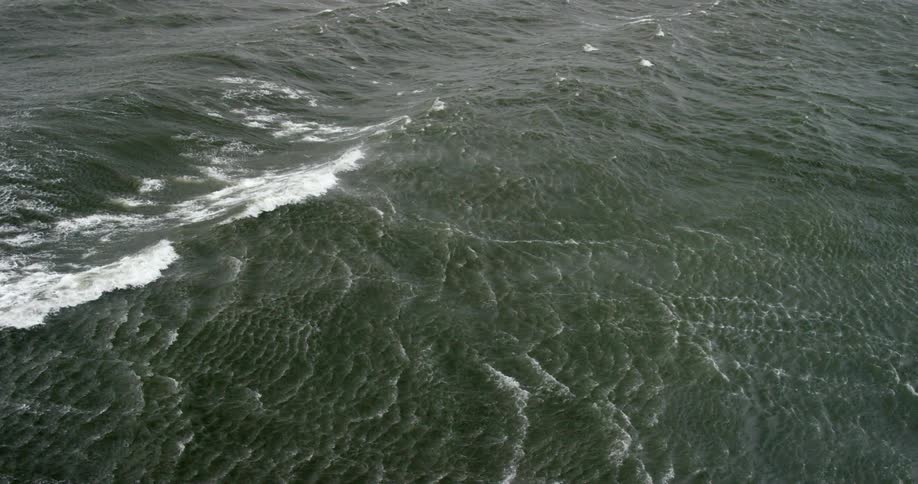 Waves are moving along the water below