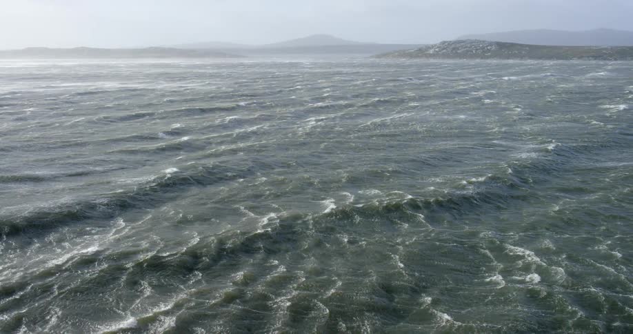The water below is rough with many waves