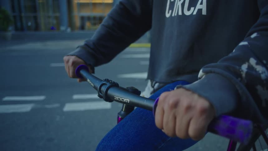 A person is sitting on a bike in a downtown city