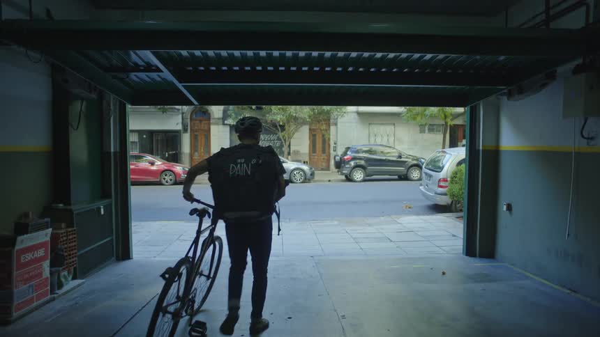 Garage door opening from the inside man walks out of garage with his bicycle