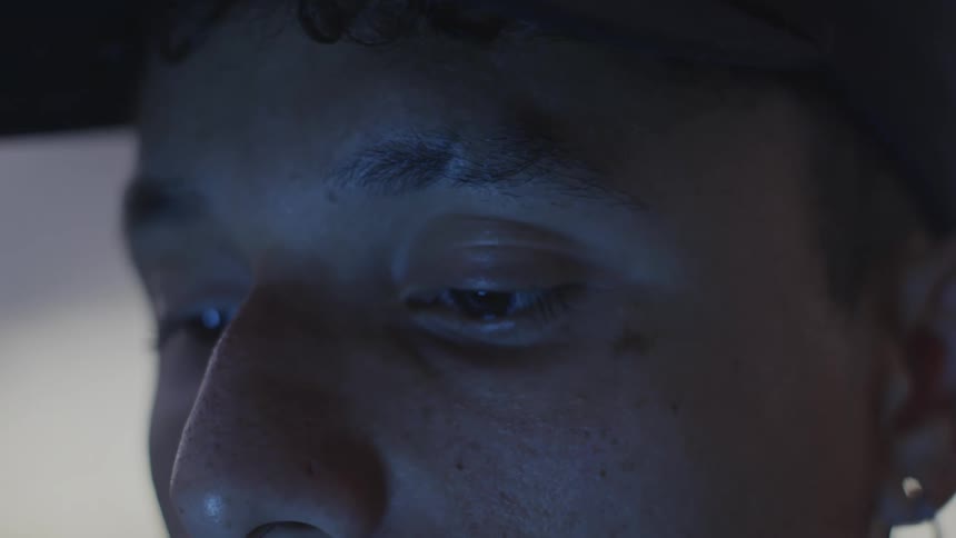 Close up view of a young mans upper face as he appears to be thinking