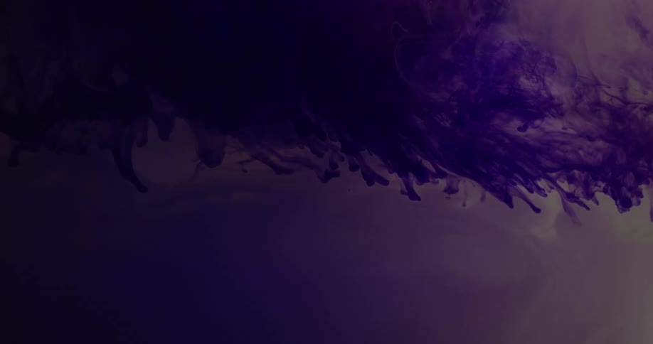 Liquid purple ink suspended on a translucent liquid under moving lights