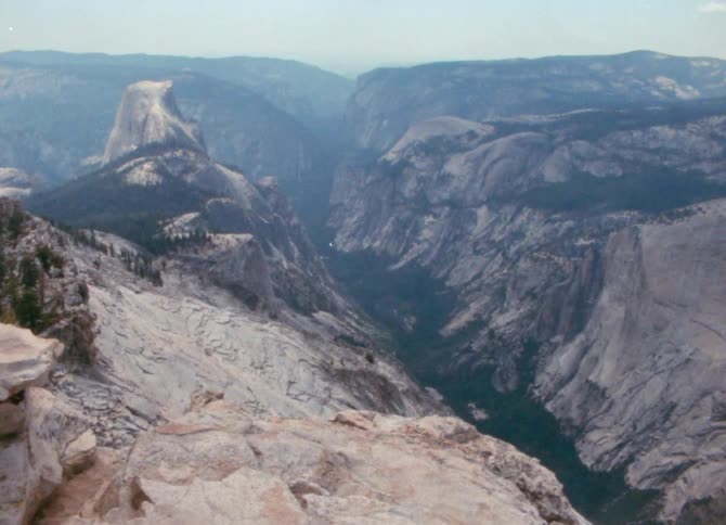 An aerial of a mountain region with a canyon in the middle